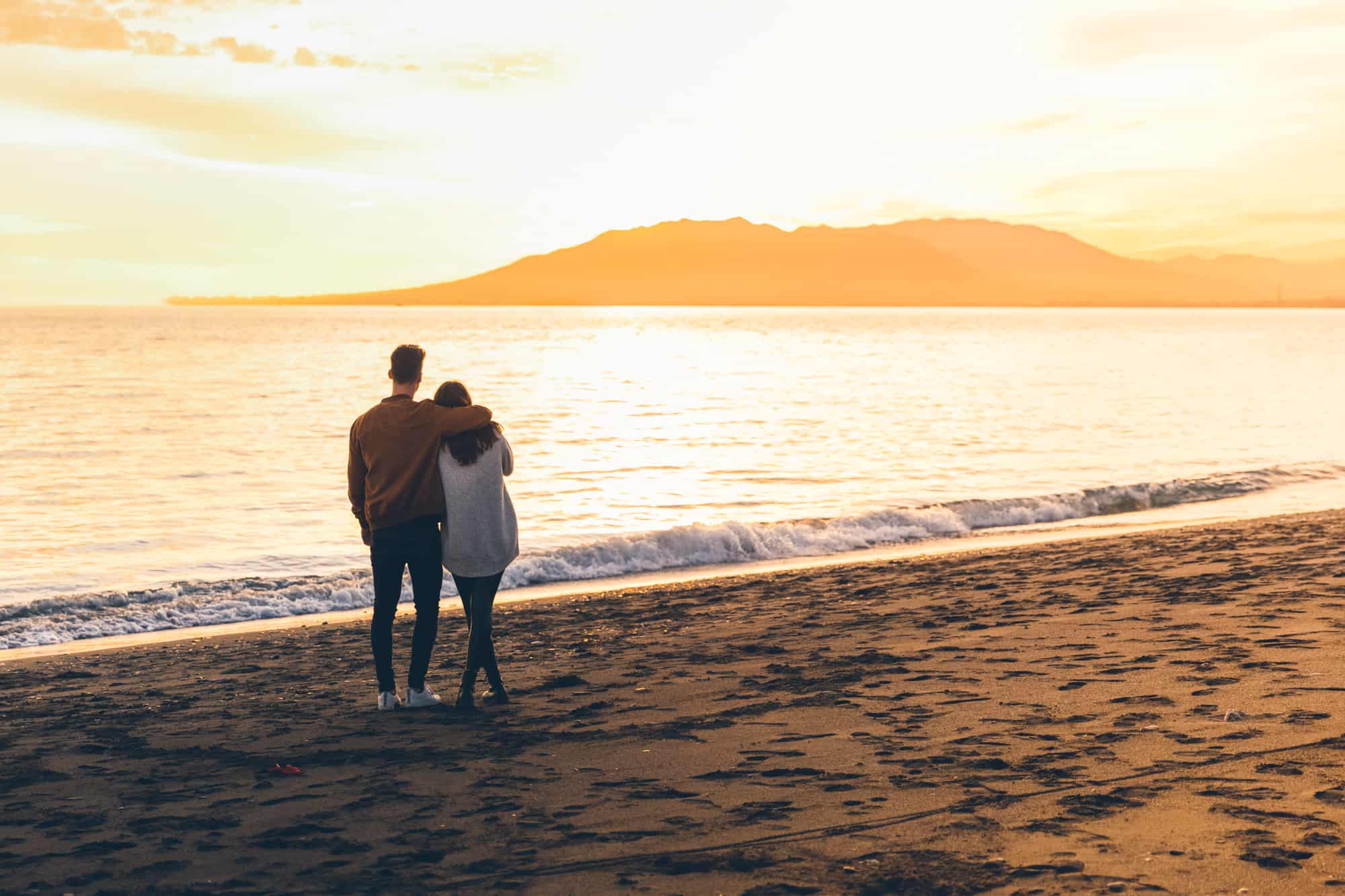 couple hugging on sea shore