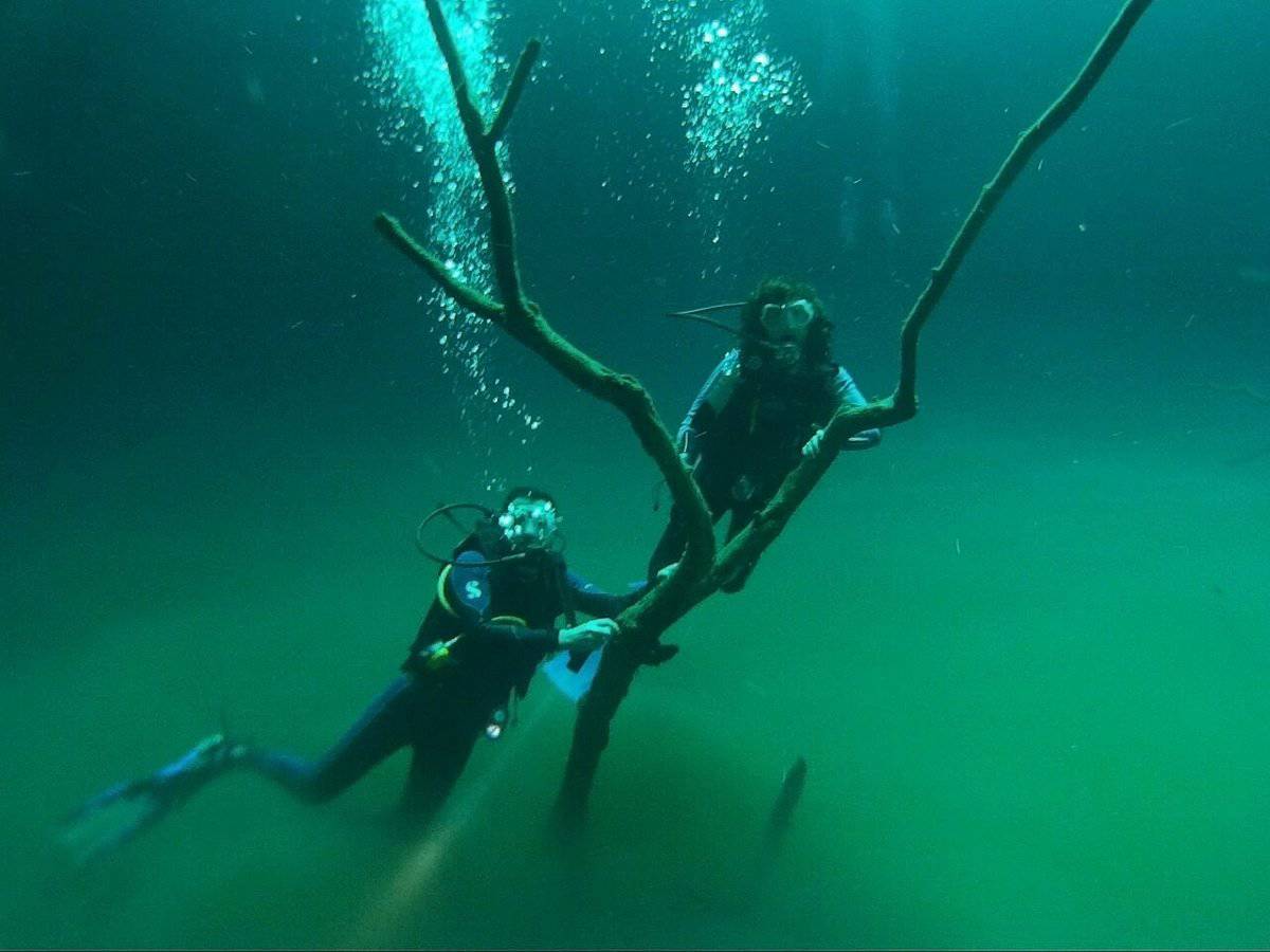 tourist underwater of cenote angelita